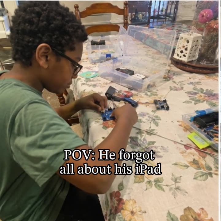 A child focused on building an electronic project with the Techbotics kit.